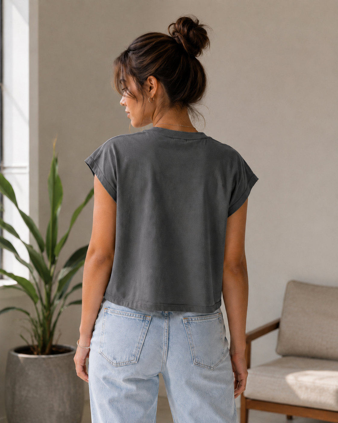 Back view of woman wearing Aloomie Castle Rock sleeveless boxy-fit T-shirt